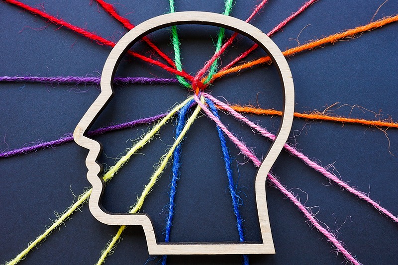 Neurodiversity image of various colours of string coming out of a graphic of a head